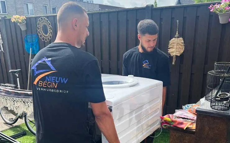 Twee verhuizers tillen een wasmachine